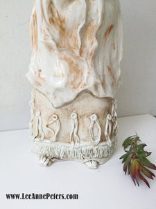Sculpture - Lady holding a baby