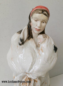 Sculpture - Lady holding a baby