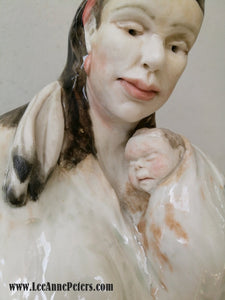 Sculpture - Lady holding a baby